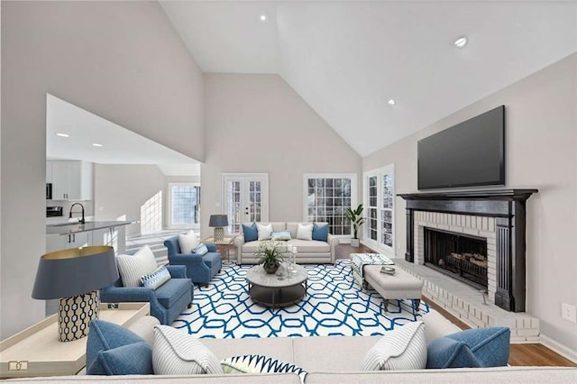 3017 Lana Ln, Marietta, GA 30066 - living room with high vaulted ceiling, a brick fireplace, baseboards, healthy amount of natural light, and wood finished floors