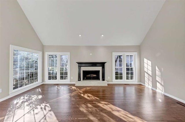 3017 Lana Ln, Marietta, GA 30066 - unfurnished living room with high vaulted ceiling, a brick fireplace, wood finished floors, and baseboards