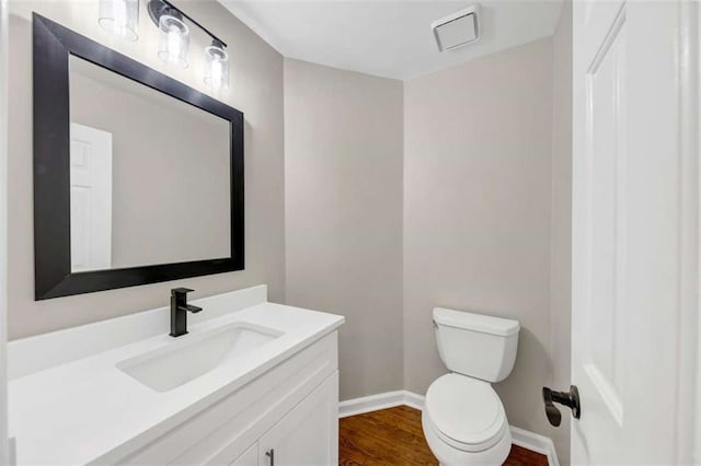 3017 Lana Ln, Marietta, GA 30066 - half bathroom featuring vanity, toilet, wood finished floors, and baseboards
