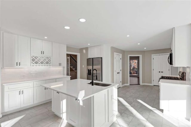 3017 Lana Ln, Marietta, GA 30066 - kitchen with stainless steel fridge with ice dispenser, a sink, recessed lighting, tasteful backsplash, and light marble finish floors