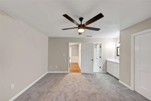 3017 Lana Ln, Marietta, GA 30066 - unfurnished bedroom featuring light colored carpet, baseboards, connected bathroom, and ceiling fan
