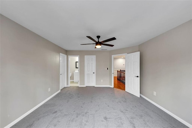 3017 Lana Ln, Marietta, GA 30066 - unfurnished bedroom with baseboards, carpet flooring, connected bathroom, and a ceiling fan