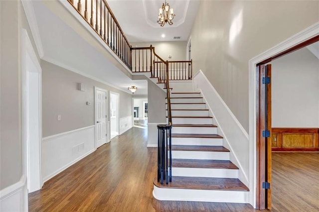 3017 Lana Ln, Marietta, GA 30066 - stairs featuring wood finished floors, a chandelier, and wainscoting