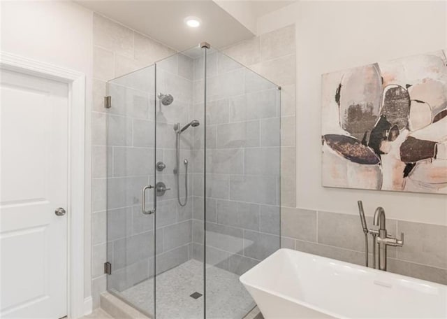 bathroom featuring sink and independent shower and bath