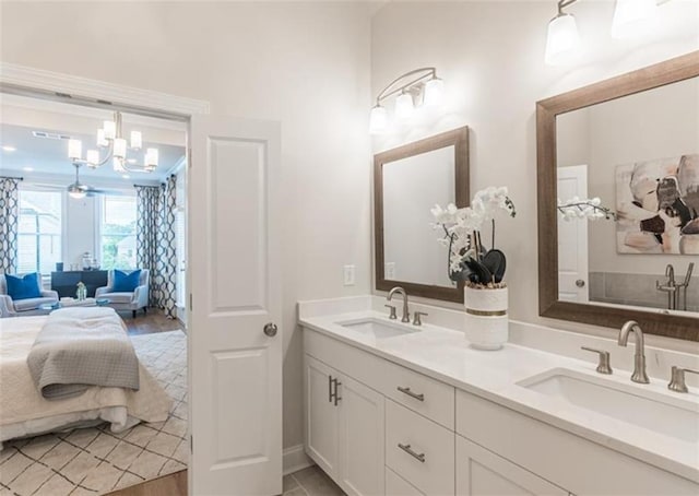 bathroom featuring hardwood / wood-style flooring, an inviting chandelier, and vanity