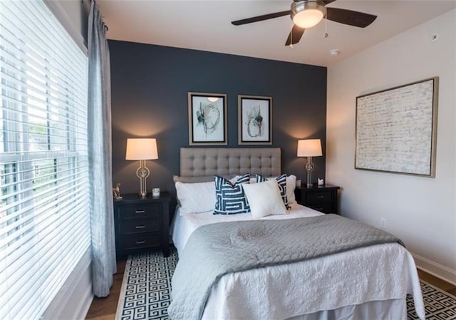 bedroom with dark wood-type flooring and ceiling fan