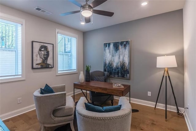 office with ceiling fan, hardwood / wood-style flooring, and a healthy amount of sunlight