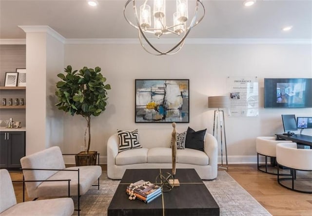 living room featuring crown molding, a notable chandelier, and light hardwood / wood-style floors