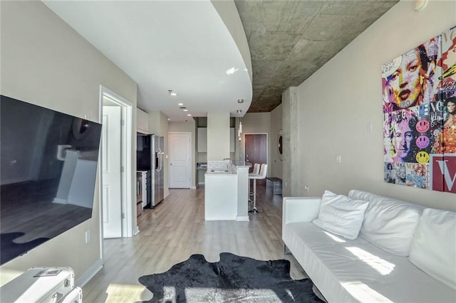 living room featuring light wood-type flooring and baseboards