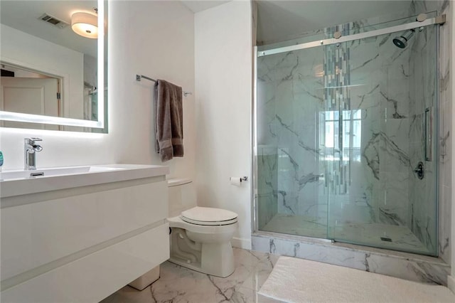 bathroom with marble finish floors, toilet, a marble finish shower, and vanity