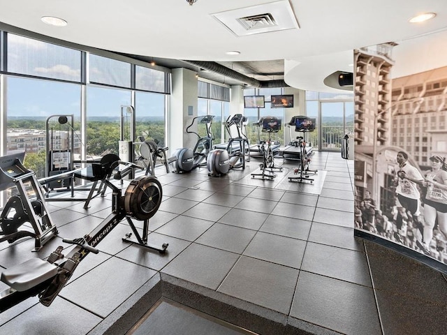 gym with floor to ceiling windows and recessed lighting