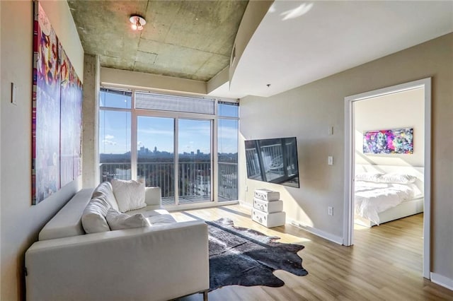 living area with wood finished floors and baseboards