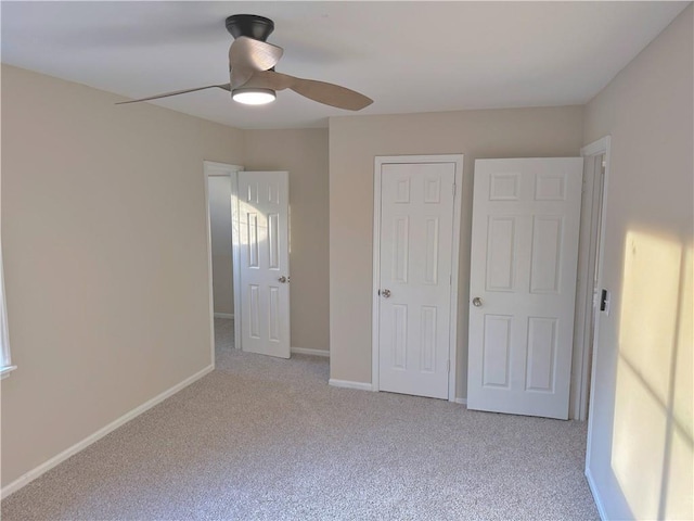 unfurnished bedroom featuring light colored carpet and ceiling fan