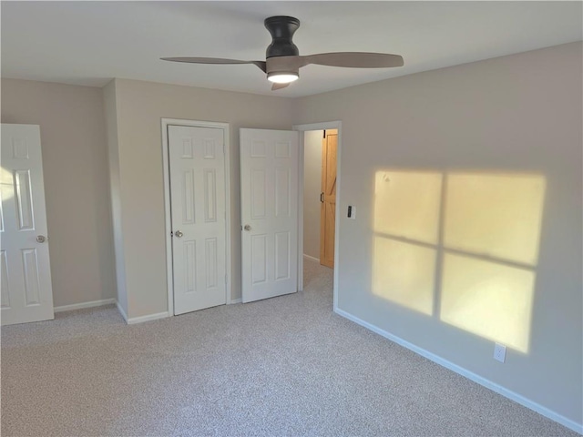 unfurnished bedroom with light carpet and ceiling fan