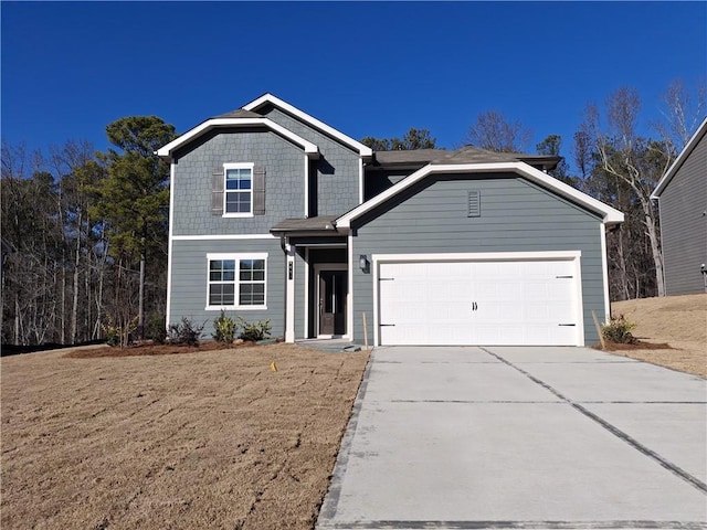 view of front property with a garage and a front yard