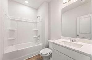 full bathroom with shower / bathtub combination, vanity, and toilet