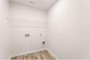 laundry area with hardwood / wood-style floors, washer hookup, and hookup for an electric dryer