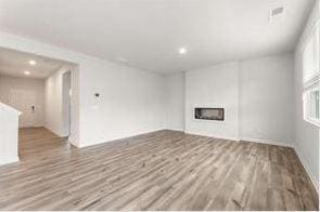 unfurnished living room with light hardwood / wood-style flooring and a fireplace