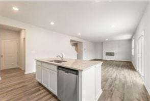 kitchen featuring white cabinetry, dark hardwood / wood-style floors, dishwasher, and a center island with sink