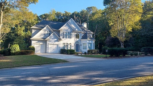 view of front of house featuring a front lawn and a garage