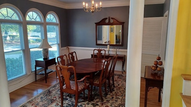 dining room featuring a chandelier, hardwood / wood-style flooring, and ornamental molding