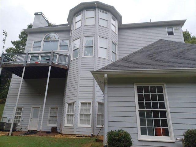 back of property featuring a balcony and central air condition unit