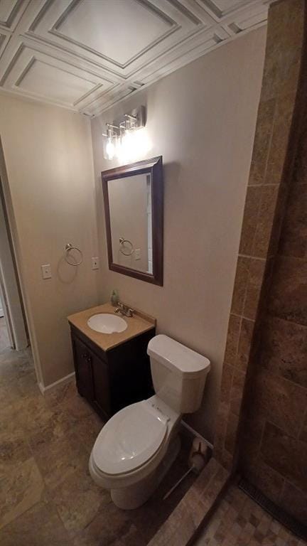 bathroom featuring vanity, coffered ceiling, and toilet