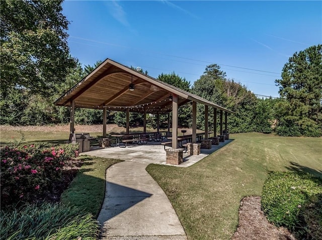 surrounding community featuring a gazebo, a lawn, and a patio