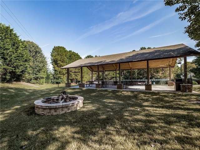 view of home's community with a gazebo, an outdoor fire pit, a patio area, and a lawn