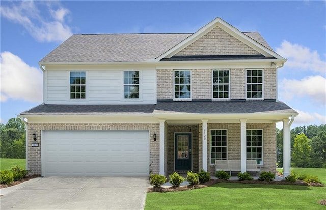 craftsman-style house with a front lawn, a garage, and a porch