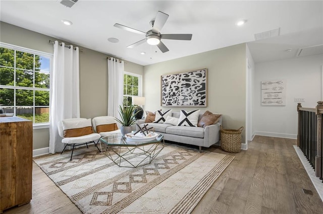 living room with hardwood / wood-style flooring, ceiling fan, and a healthy amount of sunlight