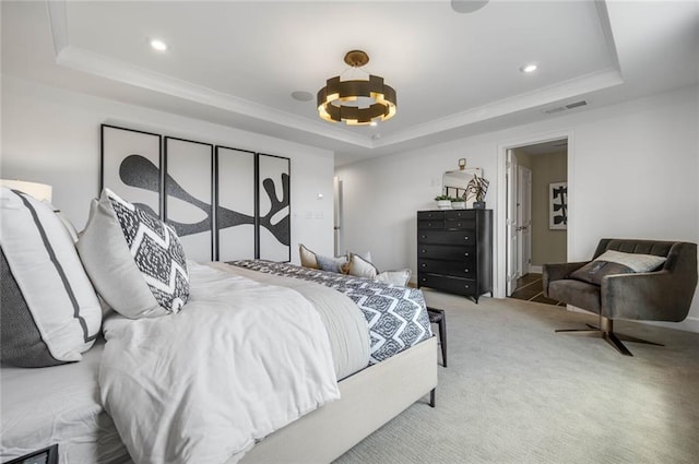 carpeted bedroom with crown molding, a tray ceiling, and a chandelier