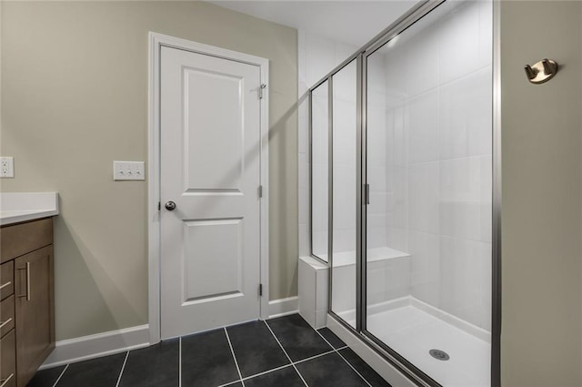 bathroom with vanity, tile patterned floors, and a shower with door