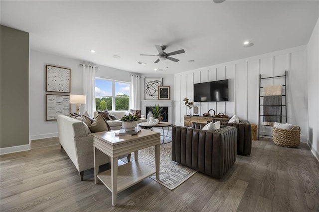 living room featuring hardwood / wood-style flooring and ceiling fan