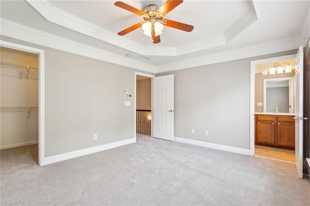 2252 Limehurst Dr NE, Atlanta, GA 30319 - unfurnished bedroom featuring a raised ceiling, crown molding, a spacious closet, light carpet, and a closet