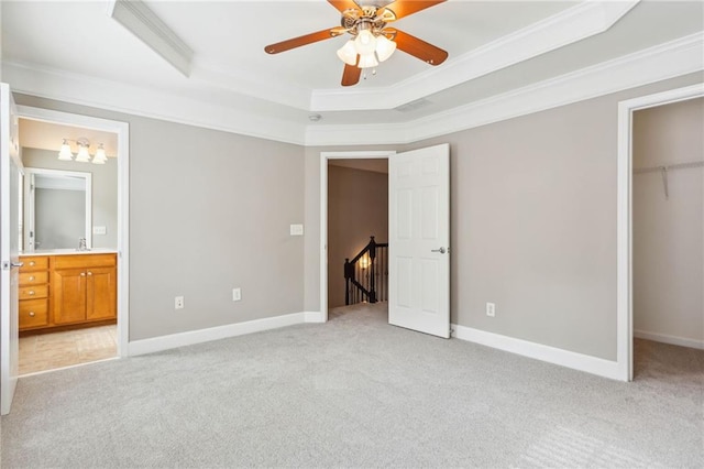 2252 Limehurst Dr NE, Atlanta, GA 30319 - unfurnished bedroom with light colored carpet, crown molding, a tray ceiling, a spacious closet, and a closet