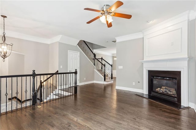 2252 Limehurst Dr NE, Atlanta, GA 30319 - unfurnished living room with wood finished floors, a ceiling fan, a glass covered fireplace, a chandelier, and crown molding