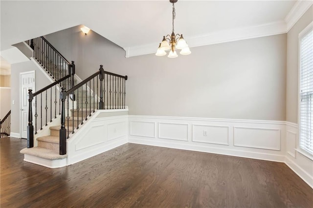 2252 Limehurst Dr NE, Atlanta, GA 30319 - unfurnished room featuring a chandelier, dark wood-style floors, stairway, wainscoting, and ornamental molding