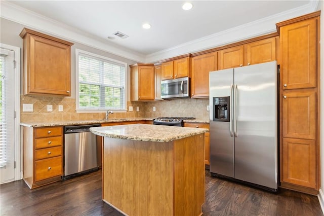 2252 Limehurst Dr NE, Atlanta, GA 30319 - kitchen featuring appliances with stainless steel finishes, dark wood finished floors, crown molding, light stone countertops, and brown cabinets