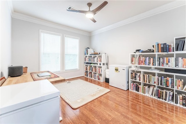 office area with wood finished floors, crown molding, and ceiling fan