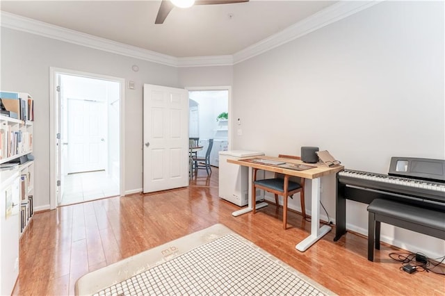 office area featuring crown molding, light wood-style flooring, and ceiling fan
