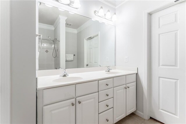 bathroom featuring walk in shower, crown molding, tile patterned flooring, and vanity