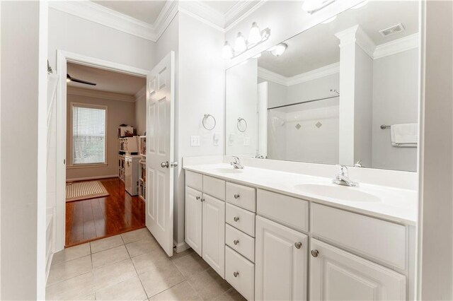 bathroom with walk in shower, vanity, crown molding, and hardwood / wood-style floors