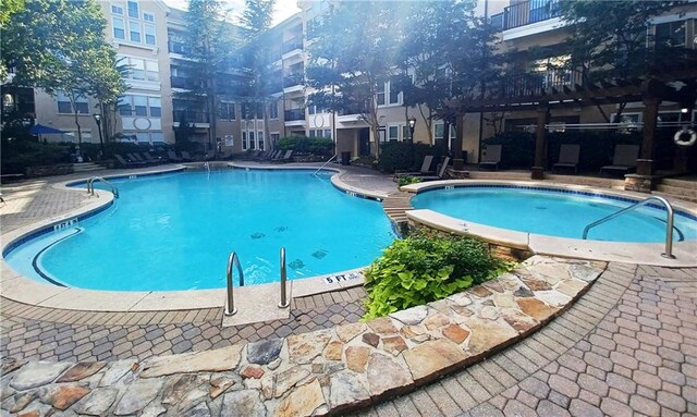 view of swimming pool featuring a patio