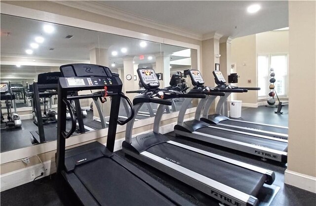 exercise room featuring ornamental molding