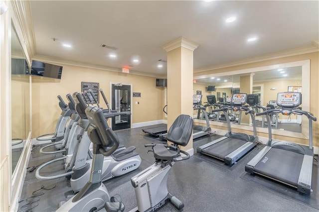 exercise room featuring baseboards, ornamental molding, and visible vents