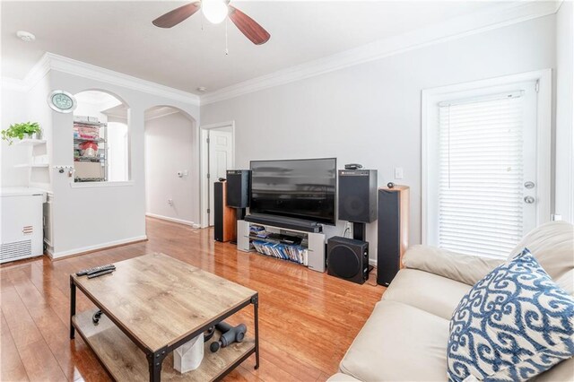 living room with crown molding, ceiling fan, and hardwood / wood-style flooring