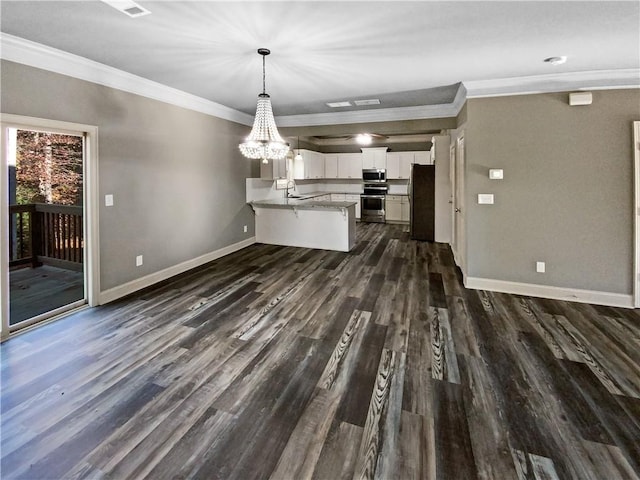 unfurnished living room featuring sink, a notable chandelier, dark hardwood / wood-style flooring, and crown molding