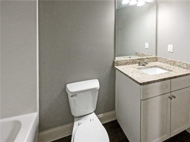 bathroom featuring vanity, toilet, and a bathtub