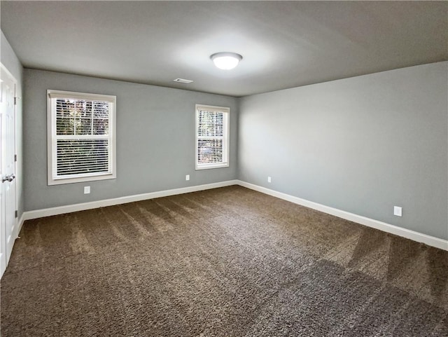 carpeted spare room with a healthy amount of sunlight